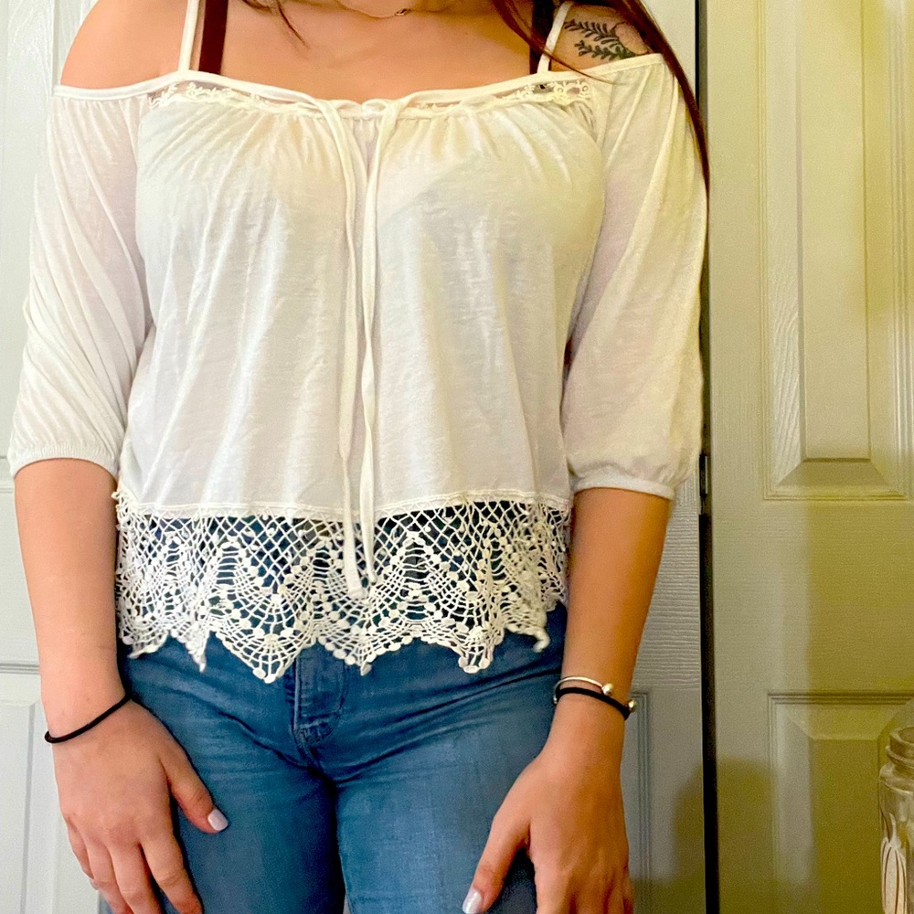 White loose fit off the shoulder blouse with lace detailing.